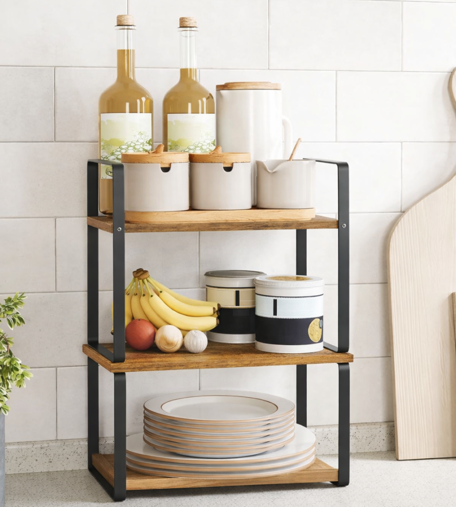 Two-tier stackable kitchen shelf organizing jars, bottles, and plates to maximize vertical counter space